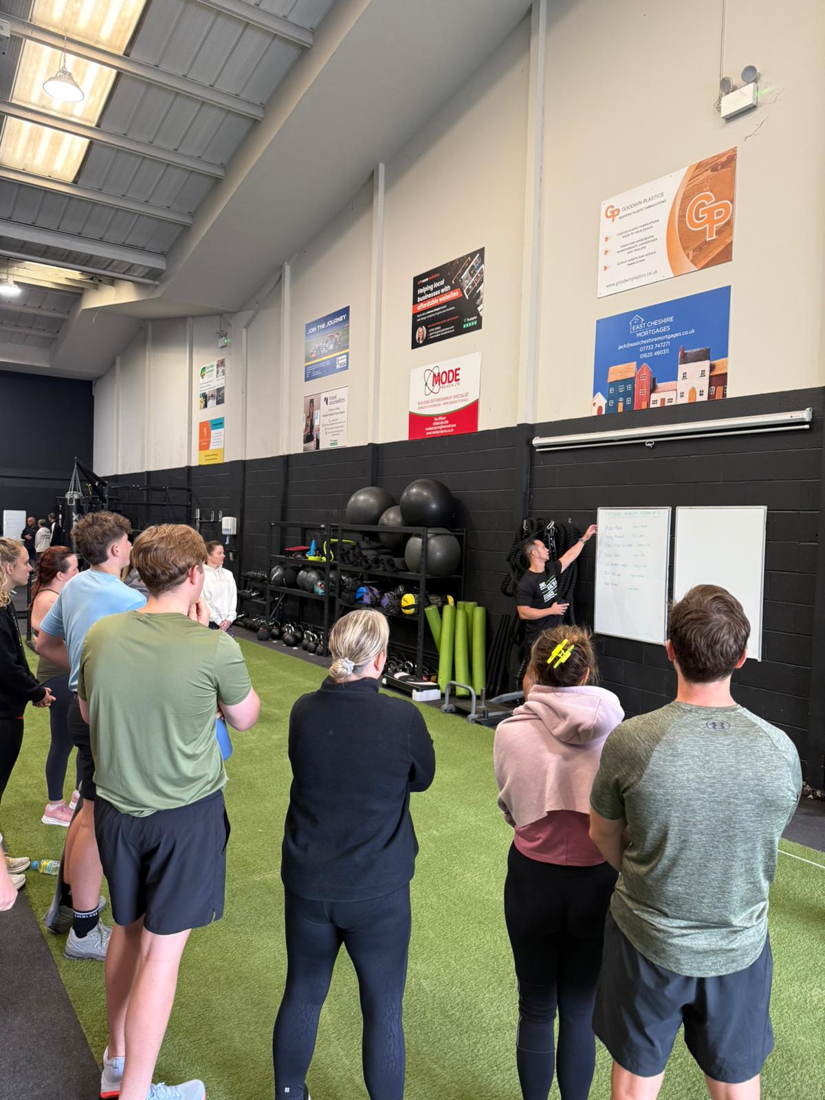 Coach leading a small group PT session at JWC